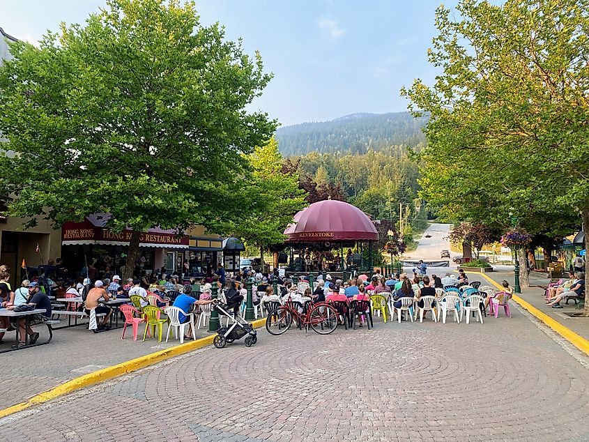 A crowded downtown with lots of people sitting and listening to a concert in downtown, Revelstoke, British Columbia, Canada. Editorial credit: christopher babcock / Shutterstock.com