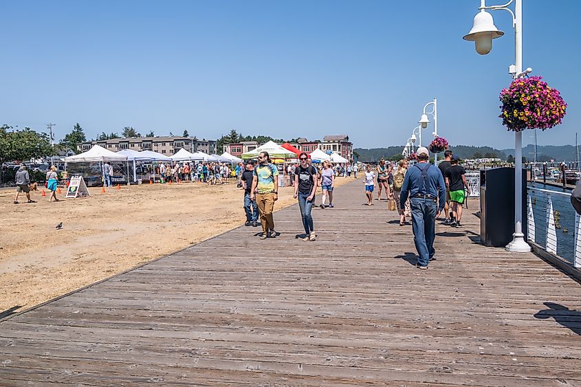 Florence, Oregon, USA. People on Boardwalk and Farmer's Market. Editorial credit: Manuela Durson / Shutterstock.com