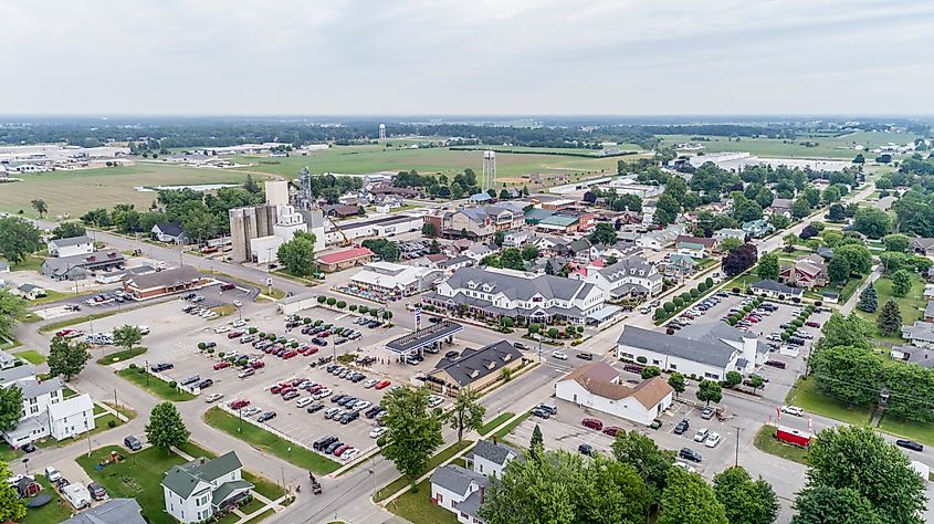 Aerial view of Shipshewana, Indiana, showcasing its rural landscape with a mix of farmland, small-town streets, and distinctive Amish businesses and homes scattered throughout the area.