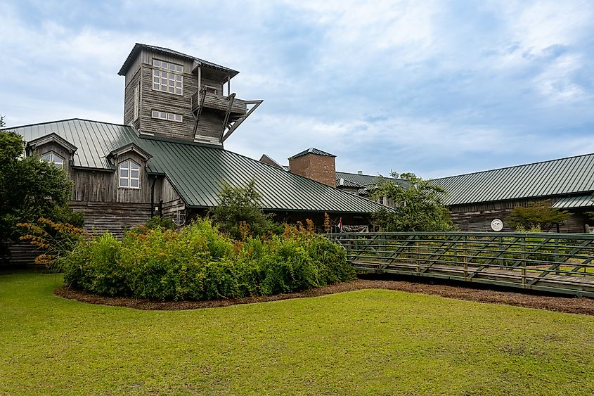 Harkers Island, North Carolina -2022: Core Sound Waterfowl Museum and Heritage Center. Outer banks museum celebrates culture of Down East. Exterior, Lookout Tower, and wildflowers. Photo credit EWY Media via Shutterstock