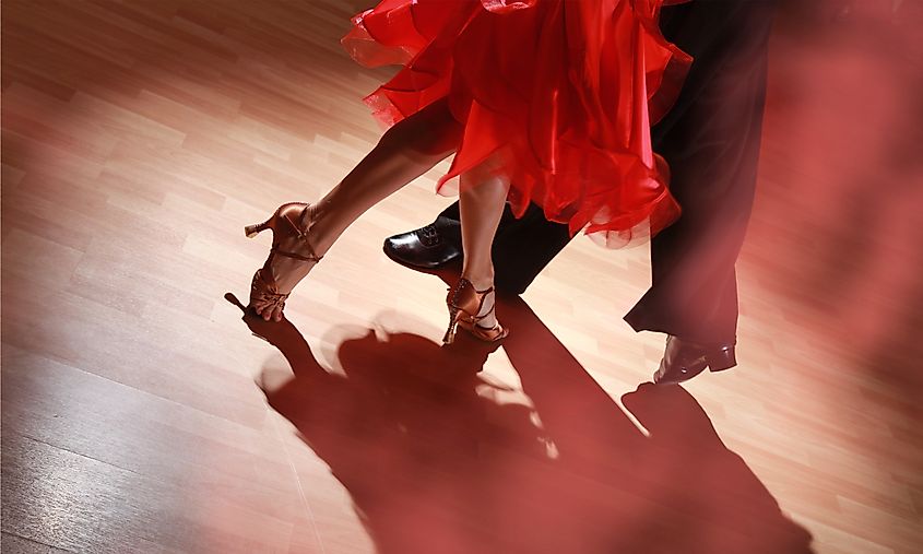 Man and woman dancing Salsa on dark