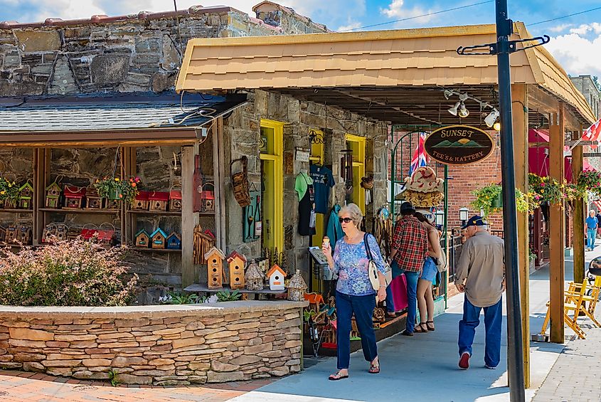 Tourists pass The Sunset Tee's & Hattery shop on Main St. in Blowing Rock, NC, USA. Editorial credit: Nolichuckyjake / Shutterstock.com