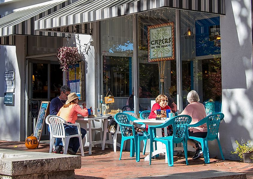 Dining alfresco on a warm autumn afternoon on the sidewalk in front of Capers, one of the eateries on the historic public square in Dahlonega, Georgia
