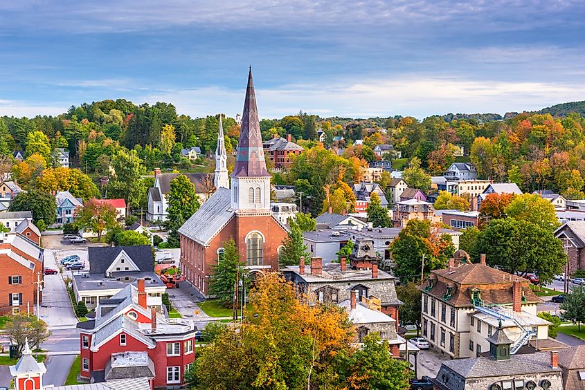 Montpelier, Vermont, autumn town skyline featuring the historic State House dome and surrounding buildings.