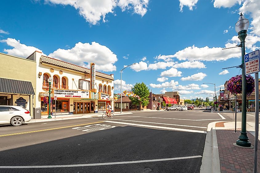 First Avenue in Sandpoint, Idaho, on a summer day. The main street is lined with buildings and bustling with activity.