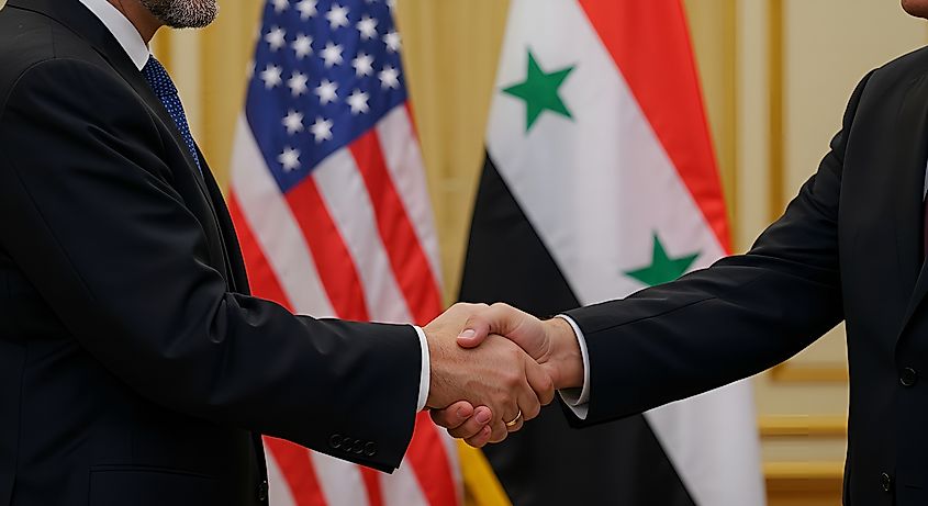 Handshake between American and Syrian officials.