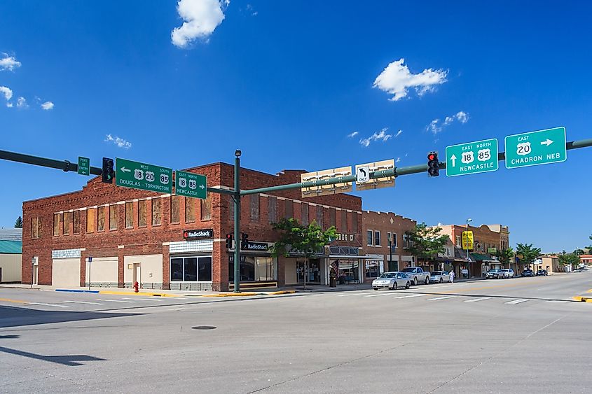 Intersection in Lusk, Wyoming, with surrounding buildings and road signs