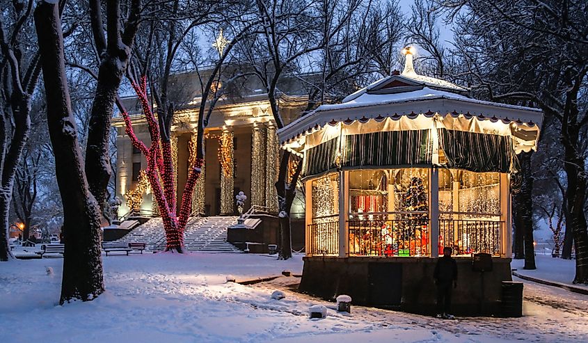 Holiday lights in the fresh snow around decorated gazebo at the Yavapai County Courthouse in Prescott, Arizona.