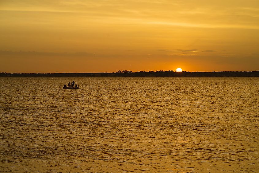 A view of sunset and a boat in Lake Conroe, Texas