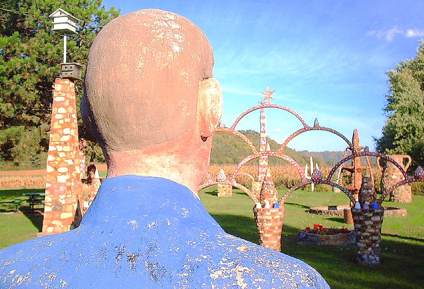 A self-portrait sculpture of Herman Rusch looking on to his other sculptures at Prairie Moon Sculpture Garden & Museum in Fountain City, Wisconsin.