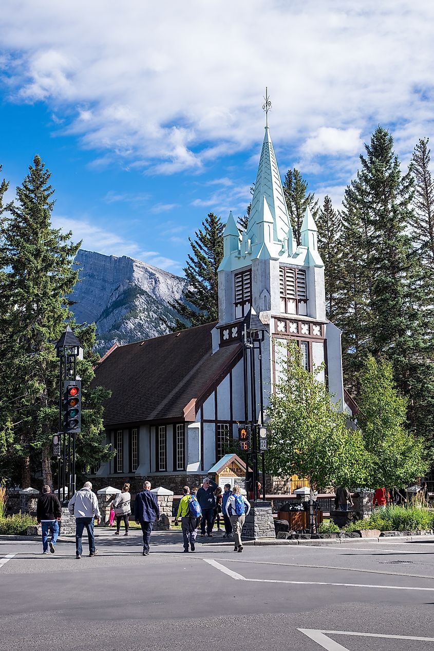 BANFF, ALBERTA, CANADA - 2016 SEPT 9: St. Paul's Presbyterian Church with its imposing spire on a sunny day with mountains behind