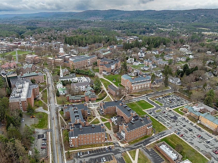 Aerial photo of Hanover, New Hampshire, in spring on a partly cloudy day, showcasing the town’s lush greenery and picturesque surroundings.