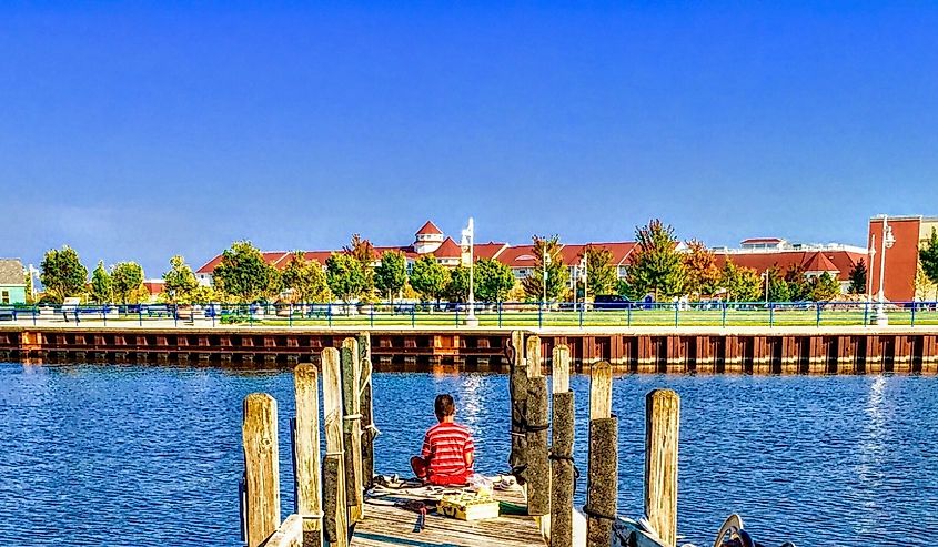Person sitting on the docks in Sheboygan, Wisconsin, United States