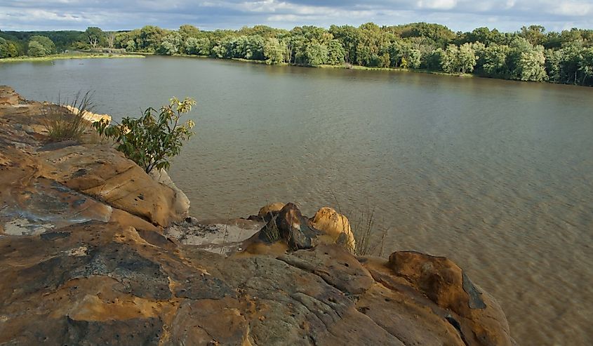 The Illinois River flows lazily by bluffs at Buffalo Rock State Park on a summer's evening