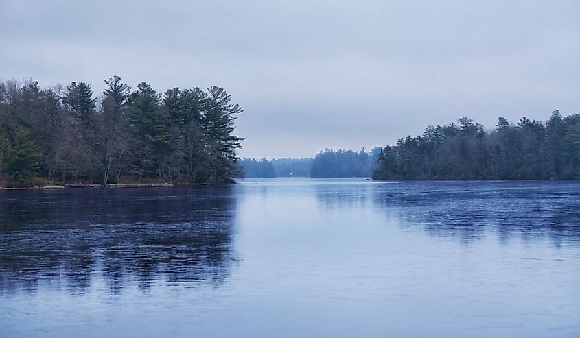 Beautiful scene of a a frozen lake in winter among pines in Pocono Pines, Pennsylvania.