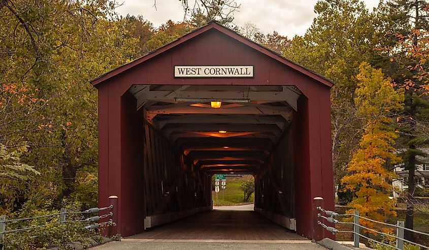 West Cornwall Covered Bridge Connecticut. Red cowered bridge with yellow autumn trees