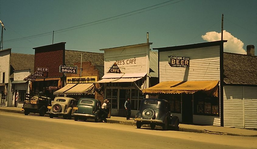 Five businesses on the main street of Cascade Idaho include two bars a cafe drug store and barber shop. 1943 photo by Russell lee.