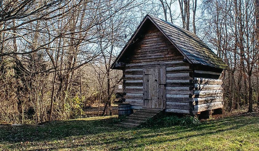 Small wooden out building in the fall with trees, taken at Bethania, North Carolina