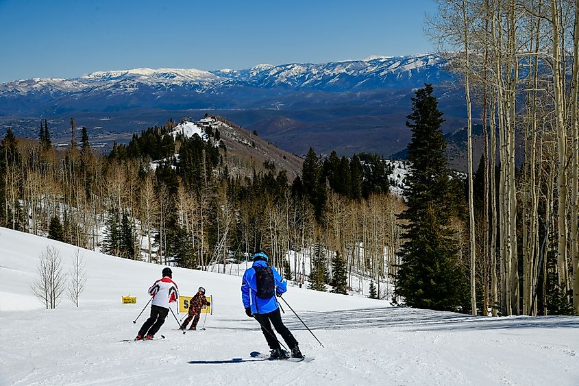 Skiers head downhill at a Park City resort.