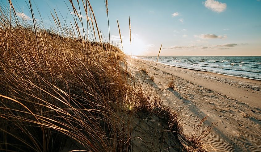 Sun sets over a beach on Lake Michigan in Indiana Dunes National Park.