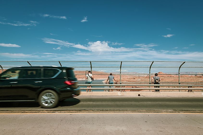 People look down on the Colorado River from Glen Canyon Dam