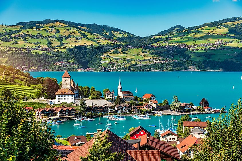 View of Spiez Church and town on the shore of Lake Thun in Spiez, Switzerland.
