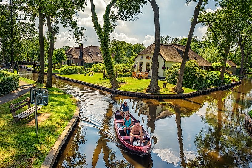 Tourists on a sightseeing boat in the Dutch village of Giethoorn, Netherlands