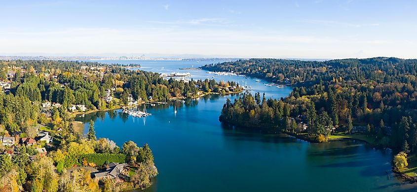Aerial view of winding harbor with Bainbridge Island, Mount Rainier, and Seattle in the background.