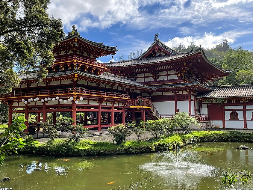 Byodo temple in Kaneohe Hawaii structures with green pond on sunny day. Editorial credit: Melissa Herzog / Shutterstock.com