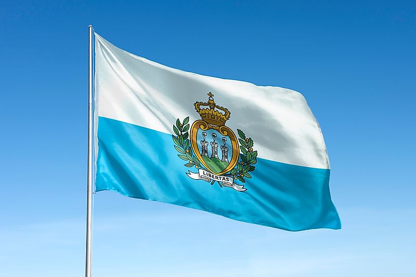 San Marino flag waving against a clear blue sky