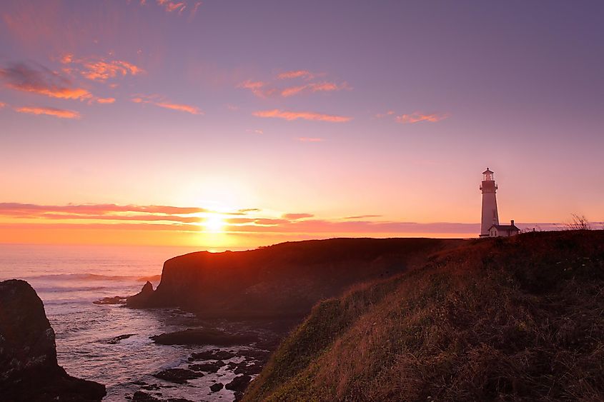 Yaquina Head Lighthouse and Pacific Ocean at sunset.
