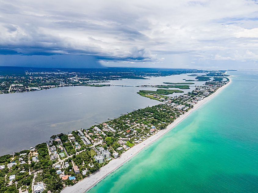 Aerial drone view of Boca Grande Island, Florida, showcasing the island's pristine beaches, crystal-clear waters, and lush landscapes along the Gulf of Mexico.