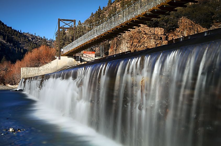 Suspension bridge with a dam control gate spanning the Truckee River in Verdi, Nevada.