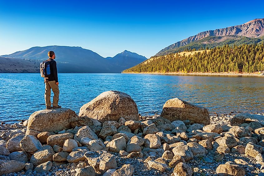 Hiker looks at view at Wallowa Lake and Wallowa Mountains near Joseph Oregon