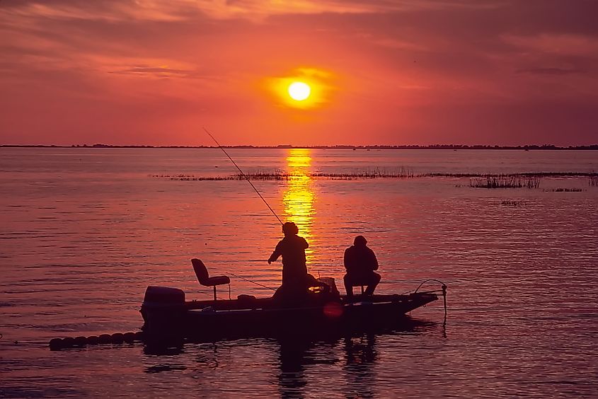 Anglers bass fishing at sunset on Lake Okeechobee, Florida