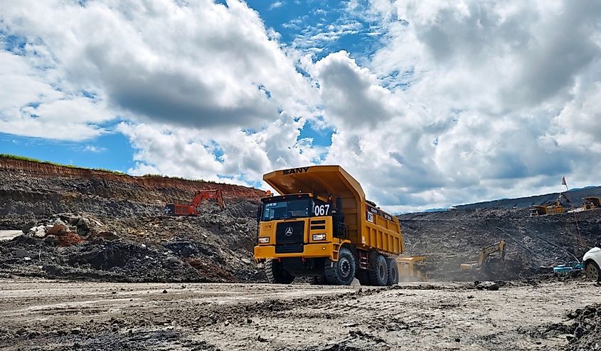 Mining activities, dump trucks are passing through the coal mine road