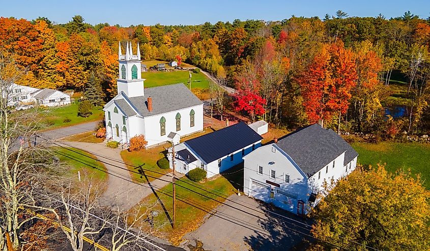 Chichester United Methodist Church aerial view in fall at 45 Main Street in historic town center of Chichester, New Hampshire.