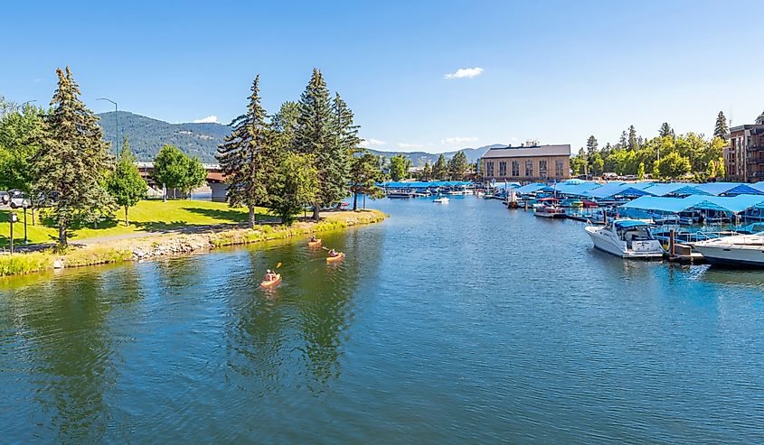 Kayakers enjoy a sunny summer day on Sand Creek alongside the marina and downtown at Lake Pend Oreille in Sandpoint, Idaho.