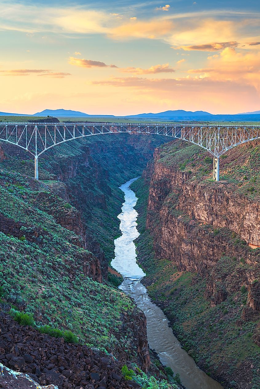 Taos, New Mexico, USA at Rio Grande Gorge Bridge over the Rio Grande at dusk.