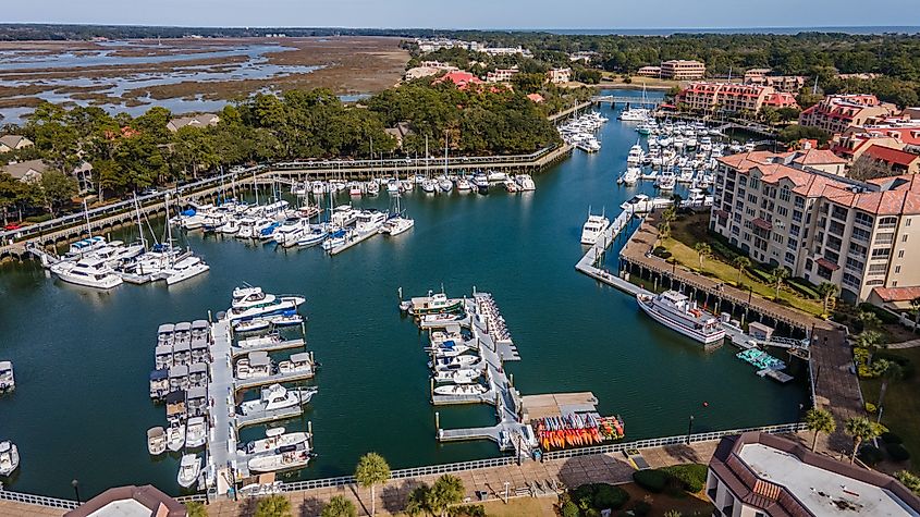 Aerial view of Hilton Head Island, showing docks, boats, and buildings.