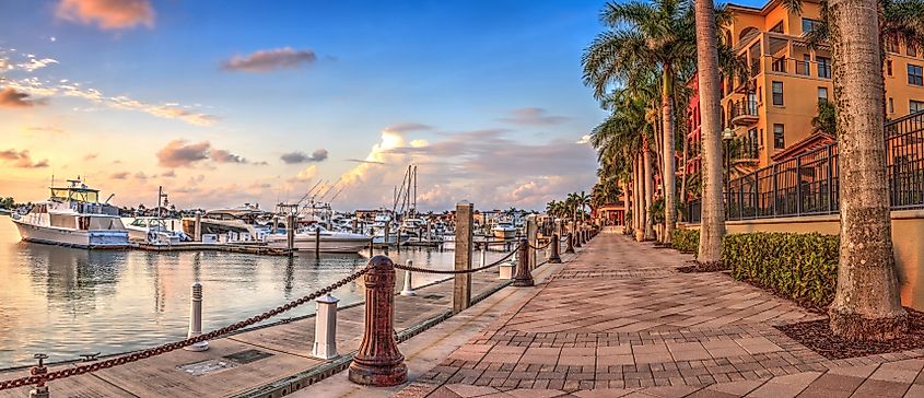 Sunset over the boats in Esplanade Harbor Marina in Marco Island, Florida.