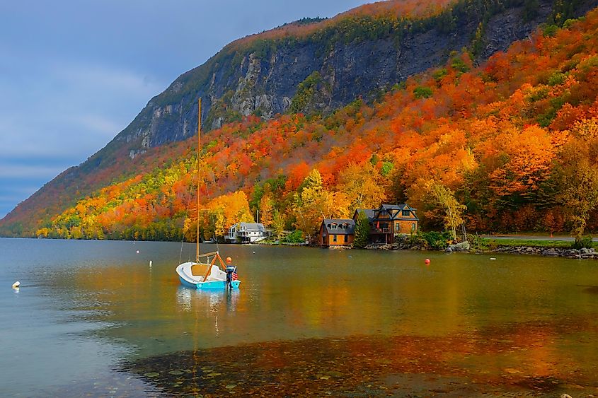 Lake Willoughby in Vermont during autumn, surrounded by vibrant fall foliage.