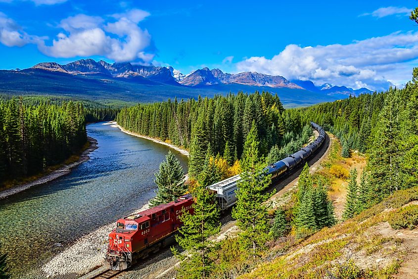 ALBERTA, CANADA - October 1,2017: Long freight train Canadian Pacific Railway (CPR) moving along Bow river in Canadian Rockies ,Banff National Park, Canadian Rockies,Canada.