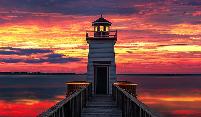 Scenic lighthouse against calm lake and sunset sky,Grand Rivers Kentucky