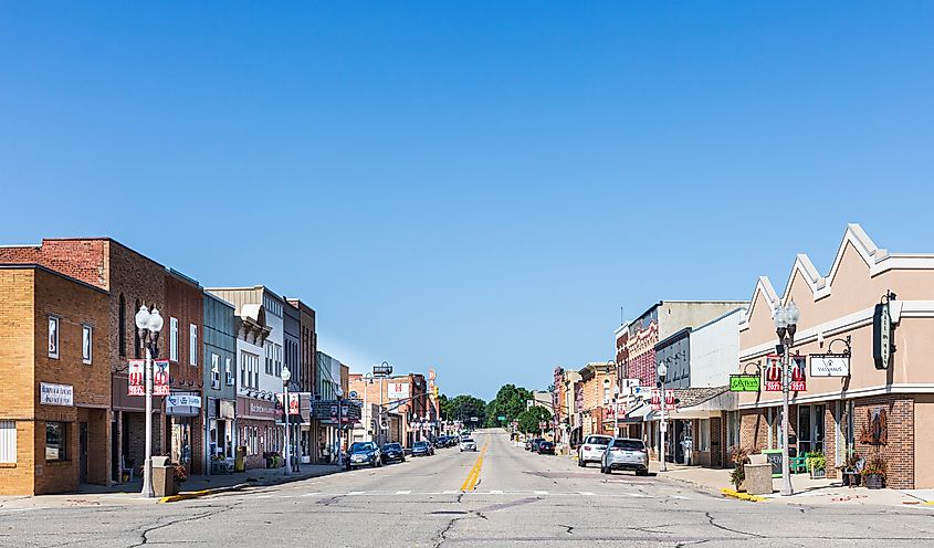 Wide angle view of Main Street in Luverne, Minnesota with multiple buildings under a blue sky