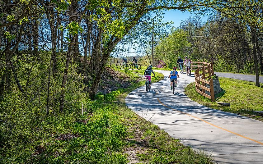 Family with kids biking on bike trail in Bella Vista, Arkansas.