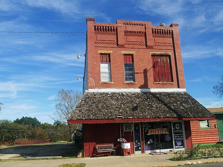 Old red brick building with awning by the roadside in Ada, Oklahoma. Editorial credit: RaksyBH / Shutterstock.com