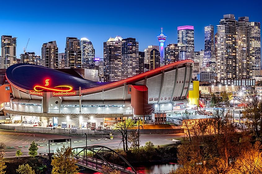 Calgary's downtown at night with the Scotiabank Saddledome in the foreground. Source: Shutterstock/Gelu Popa