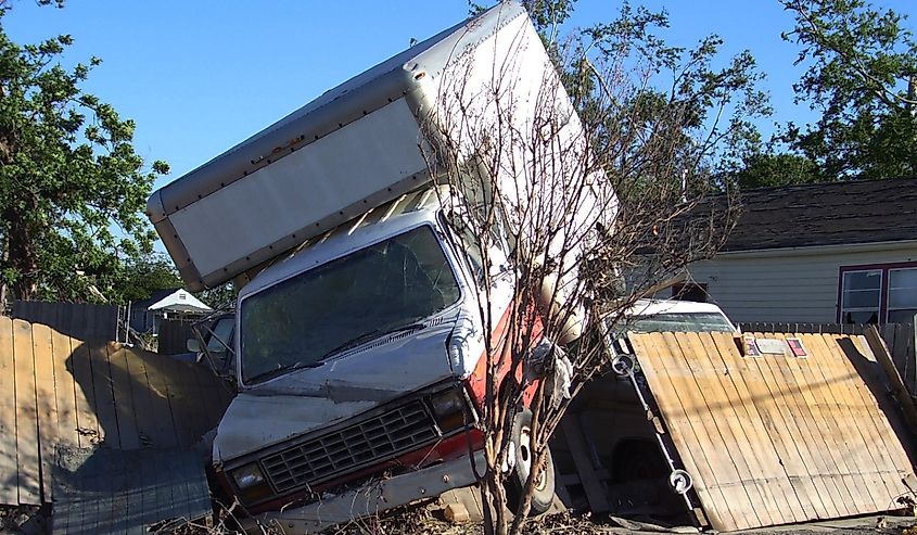 Moving truck that was picked up and landed on residential fence after Hurricane Katrina in New Orleans Louisiana