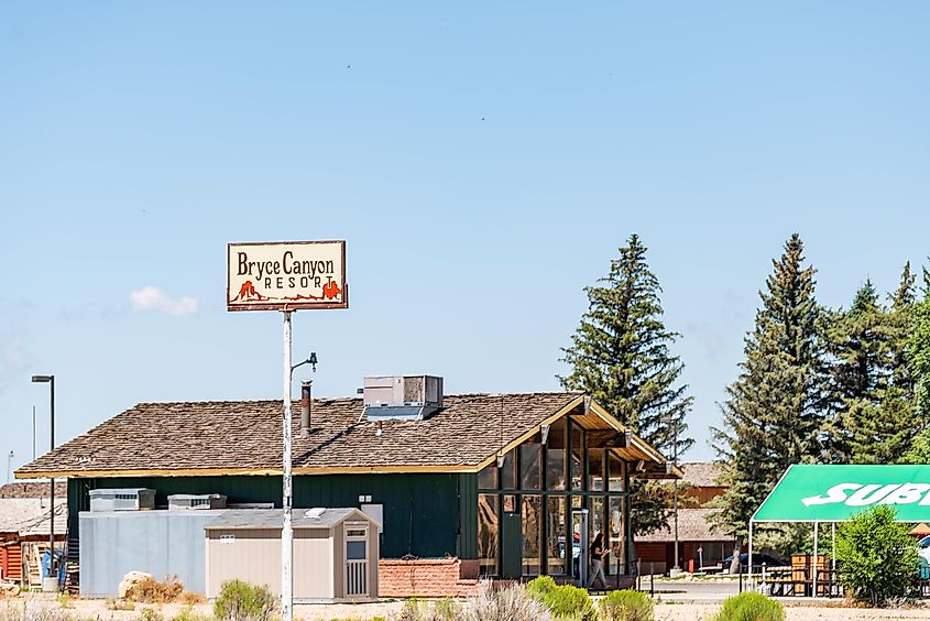 Small tourist town with sign for resort hotel near National Park with subway fast food restaurant in Bryce Canyon City, Utah